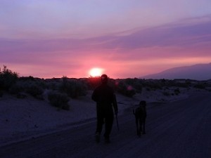Man and dog walking in smoke filled desert southwest